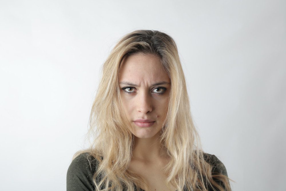 frowning blonde woman